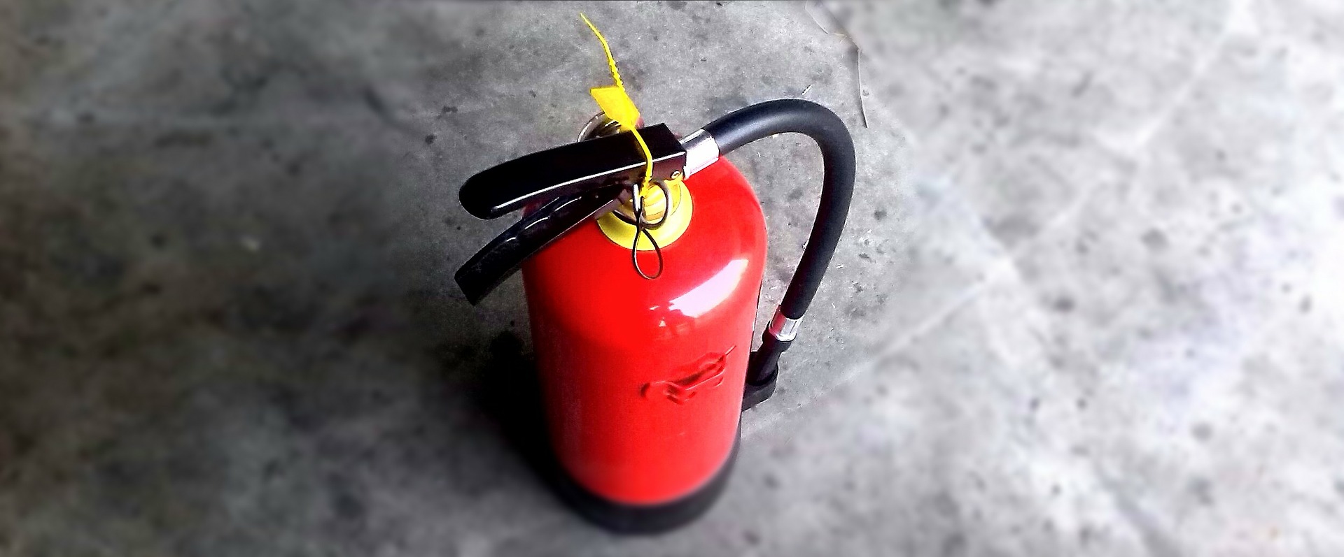 A photo of a fire extinguisher: WA Fire - Workplace Fire Safety